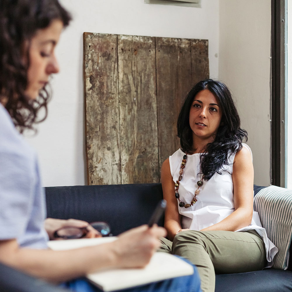 Psychotherapy session, woman talking to her psychologist in the studio