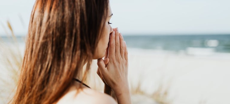 A woman meditating and thinking about everyday habits that help break free from gambling and worry