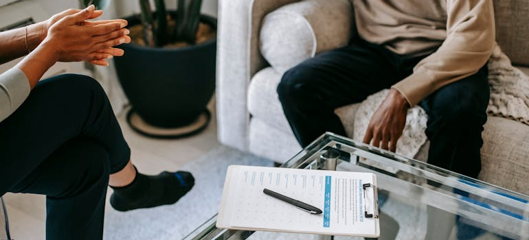 person attending a therapy session and discussing addiction or compulsive behavior