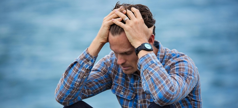A man holding his head