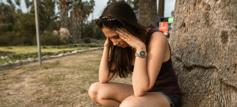 Woman Crouching while Her Hands are on Her Head