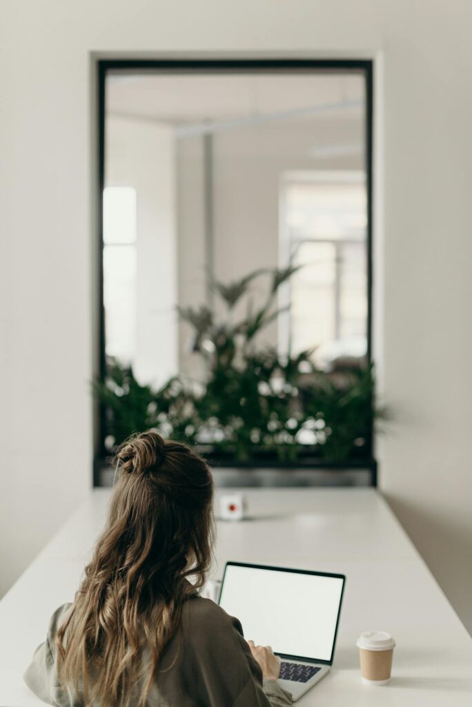 a woman using a laptop to access cbt therapy online