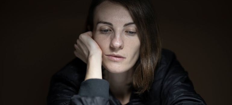 a sad woman looking down 
