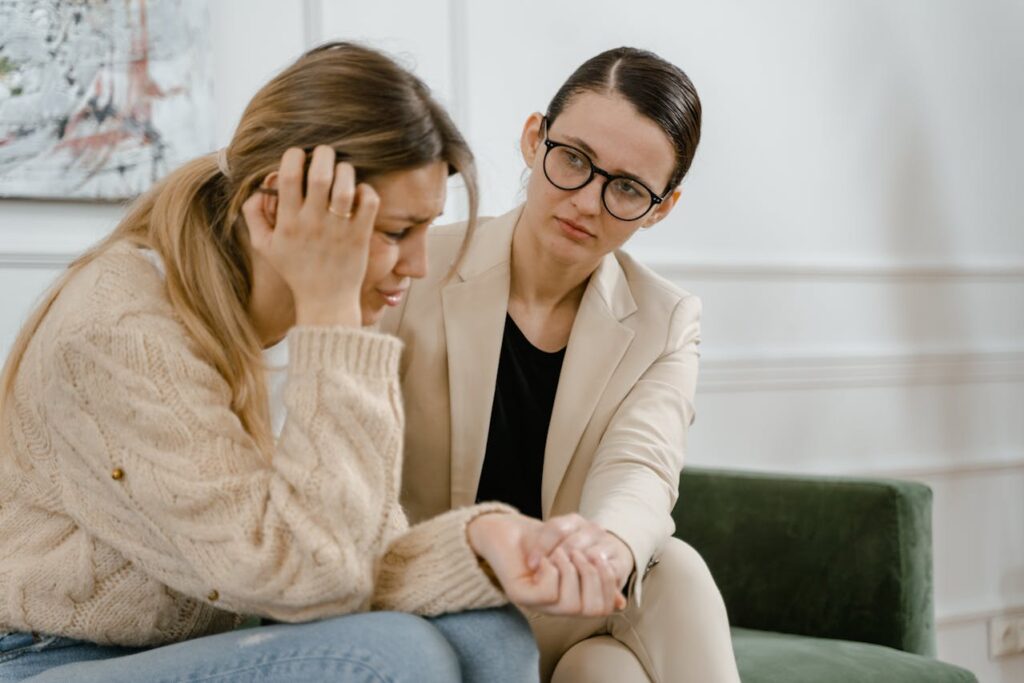 a therapist comforting a woman under stress during cognitive behavioral therapy Massachusetts session