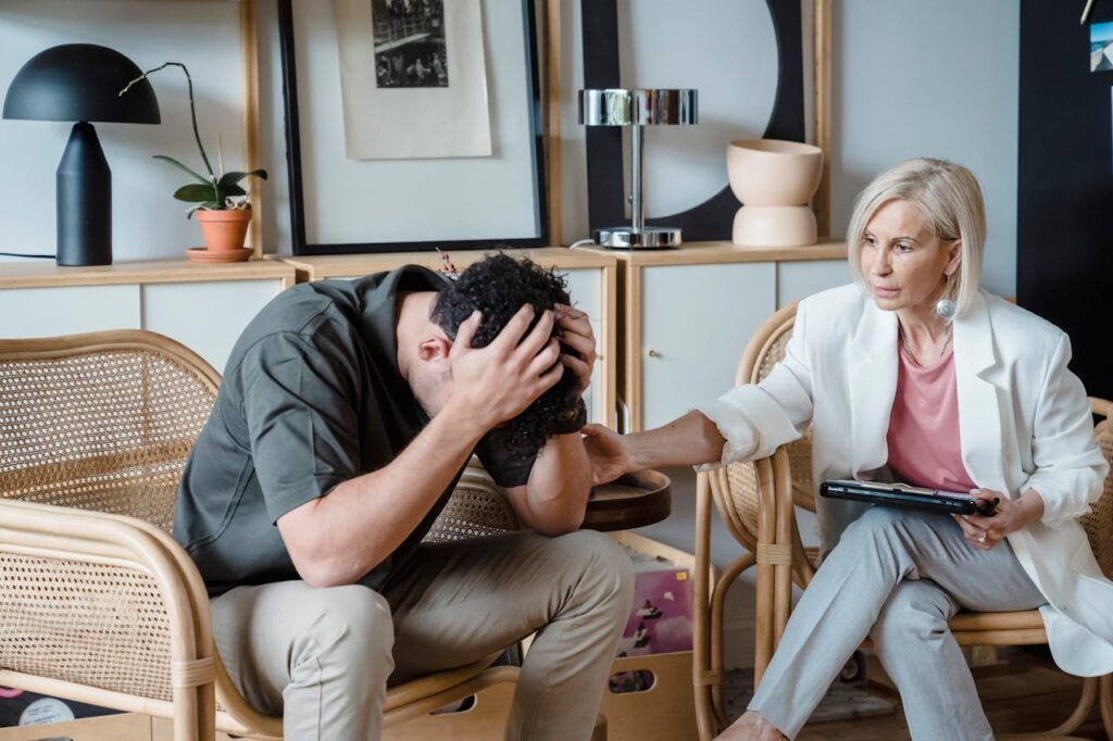 a female therapist comforting a male client