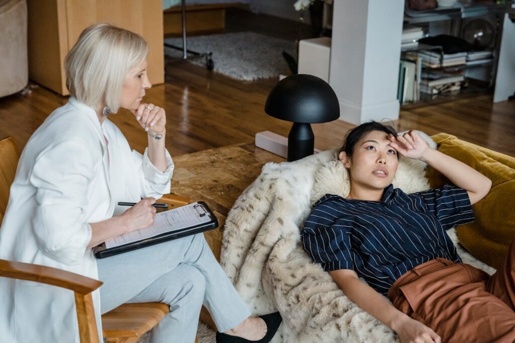woman lying on a couch while talking to a therapist about iop programs in massachusetts