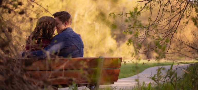 a couple on a bench kissing