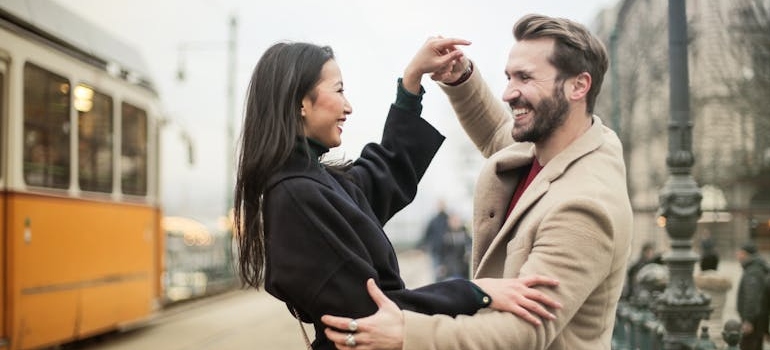 a happy couple on the street dancing after talking about Dating someone with OCD