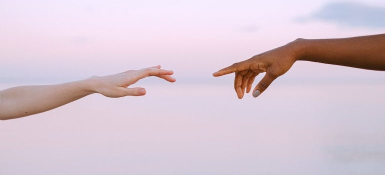 People Reaching Each Other's Hands