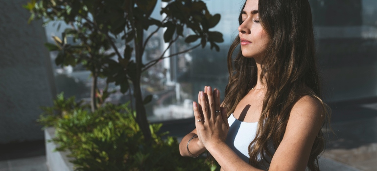 A close-up of a woman meditating.