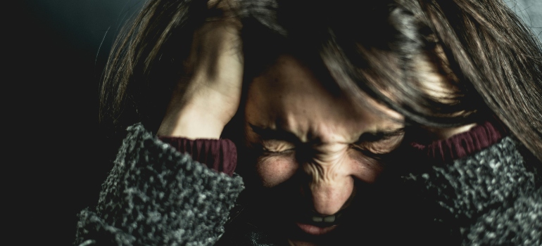 A close-up of a woman experiencing signs of anxiety.