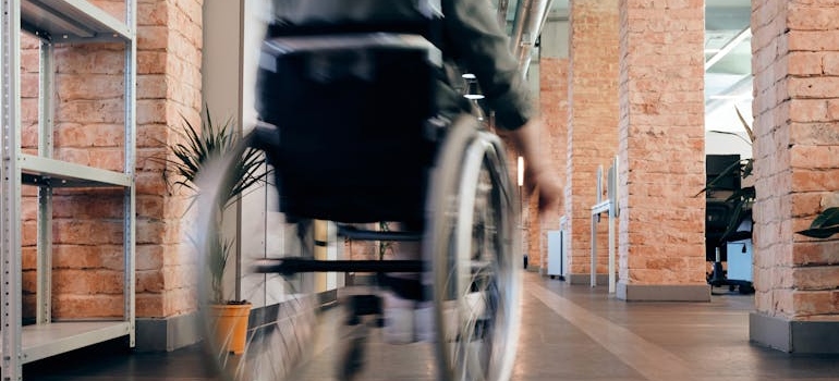 A man in the wheelchair going through a hall