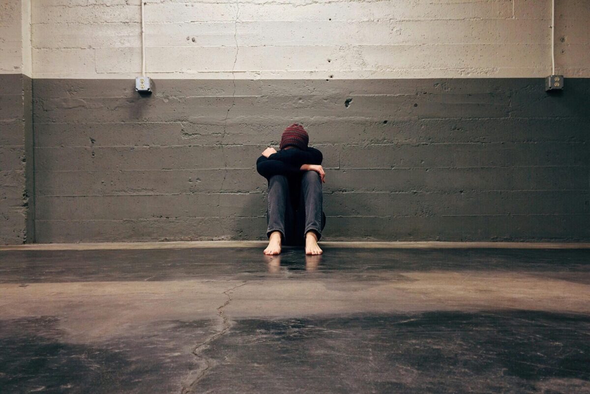 Person leaning on wall.