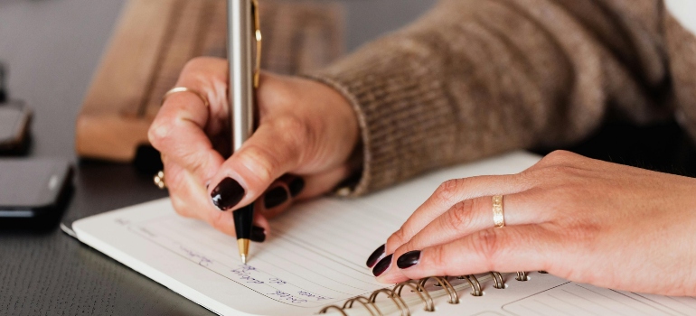 a woman writing about stages of mental health recovery