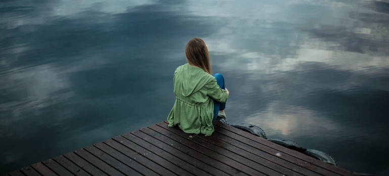 a girl sitting and looking at the distance 