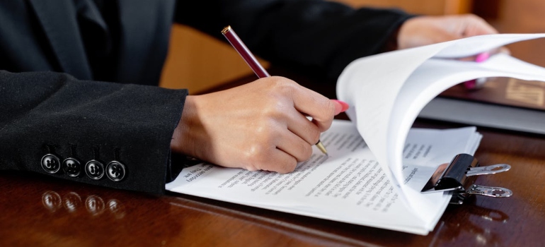 a person signing some paperwork 