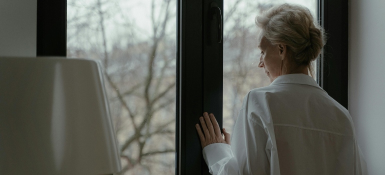 Close-up of someone looking thoughtfully out a window.