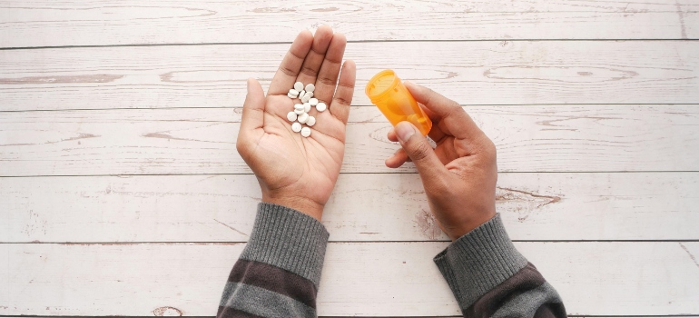 Person holding a pill bottle.